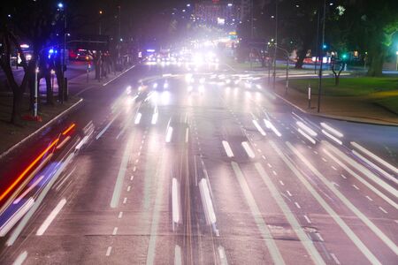 Traffic lights in motion at nightの写真素材