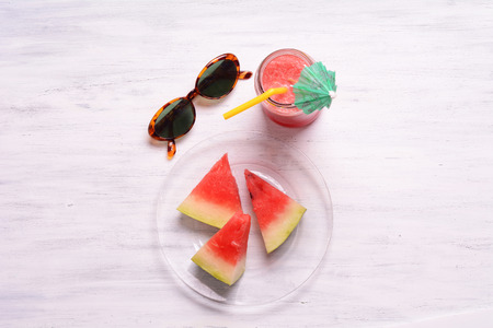 Top view of watermelon drink in glass with slices of watermelon on wooden table.の写真素材