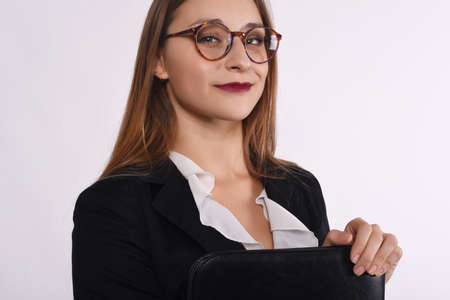 Portrait of a beautiful businesswoman with a folder. Isolated white background.の写真素材
