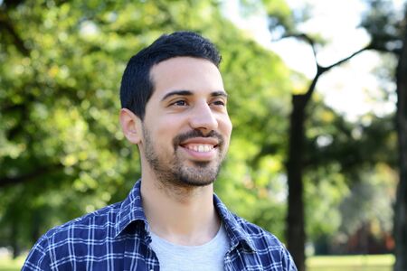 Close up of young handsome man in a park.の写真素材