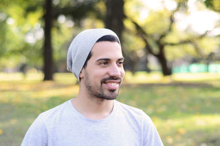 Close up of young handsome man in a park. Outdoors.の写真素材