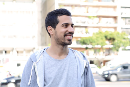 Portrait of young latin man. Urban scene. Outdoors.の写真素材