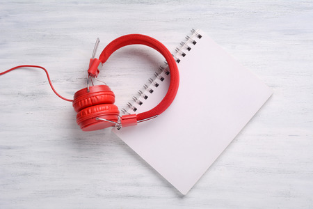 Wooden table background with Headphone and blank book page. Top viewの写真素材