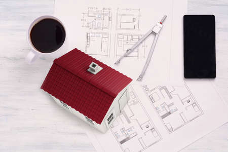 House with house plan, coffee and smartphone. Architecture concept.の写真素材