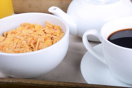 Breakfast tray with coffee and bowl of cereals.