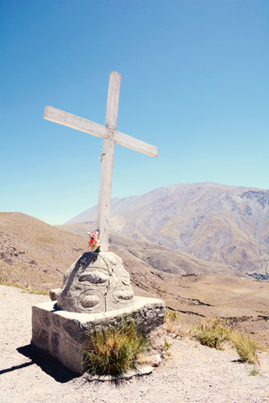Catholic cross with mountains in the background.の写真素材