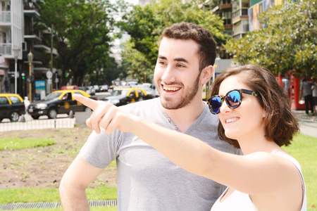 Portrait of a young beautiful tourist couple. Outdoors.の写真素材