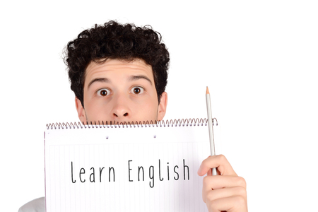 Close up of a young student holding notebook and pencil with "learn Engish" text. Education concept. Isolated white background.の写真素材