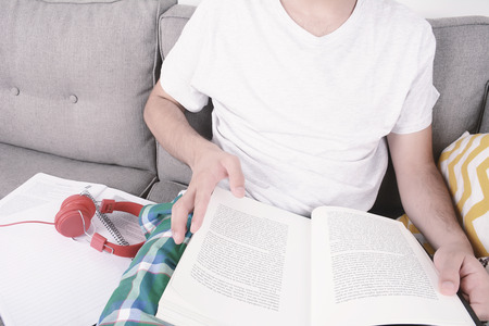Attractive young man studying with cup of coffee. Indoors.の写真素材