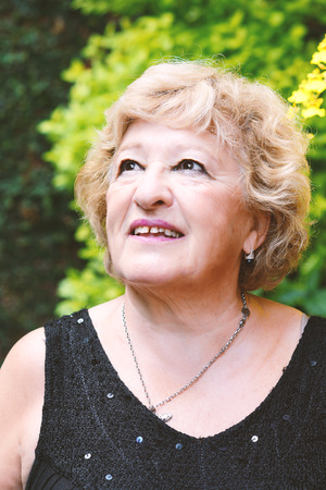 Portrait of a happy elderly woman outdoors.