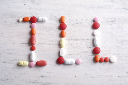Close-up of word ILL made with colorful pills. Healthcare concept.の写真素材