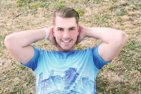 Portrait of a young handsome man doing exercises at the park. healthy concept. Outdoors.