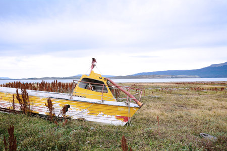 Old wooden boat abandoned ashore.のeditorial素材