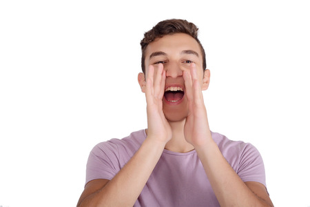 Portrait teen boy screaming with wide open mouth. Isolated white background.