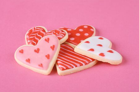Close up of heap of Valentine's day cookies. Pink background