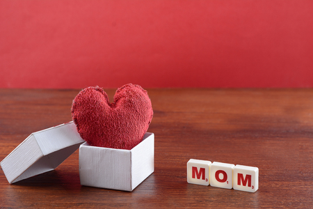 Mother's day background of gift box with red heart. Greeting conceptの写真素材