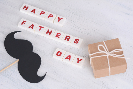 Happy Fathers Day blocks with photo booth props mustache on wooden backgroundの写真素材
