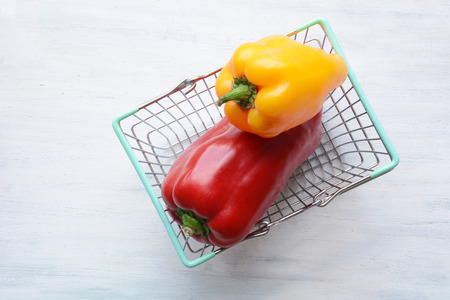 Shopping basket filled with red and yellow peppers. Colored paprika.