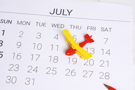 Summer Calendar Schedule, with toy airplane. Travel, tourism, holiday concept.の写真素材