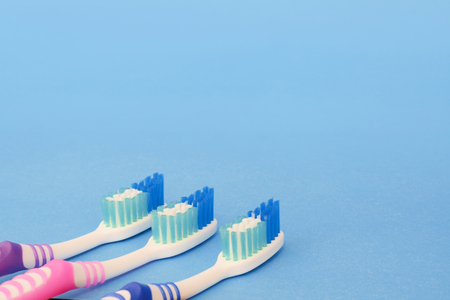 Toothbrushes with copy space on light blue backgroundの写真素材