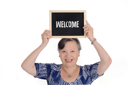 Elderly woman holding chalkboard with textの写真素材