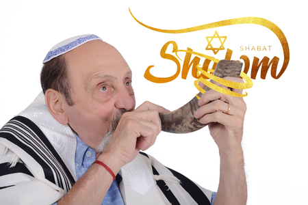 Eldery jewish man blowing the Shofar horn for the Jewish New Year holiday (Rosh Hashanah). Religion concept. Isolated white backgroundの写真素材