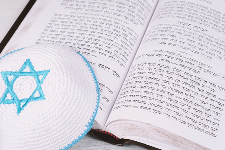 Torah with kippah on wooden background. Jewish religion conceptの写真素材
