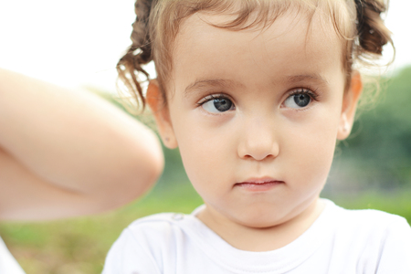 Close up Portrait of cute baby girl in the park.