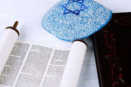Torah with kippah on wooden background. Jewish religion conceptの写真素材