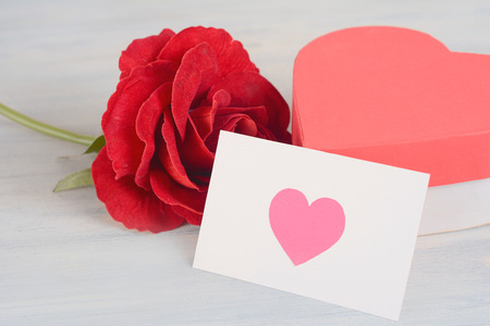 Red roses with valentines day card. Love concept. Pink backgroundの写真素材