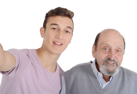 Grandfather and their teen grandson taking a selfie. Isolated on white backgroundの写真素材