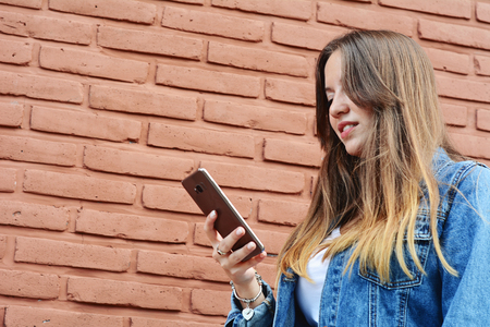 Young woman using her smartphone on the streetの写真素材