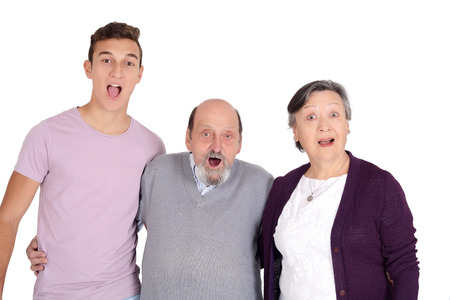Portrait of smiling grandson with his grandparents. Isolated white backgroundの写真素材