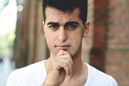Portrait of handsome young thoughtful man. Outdoors