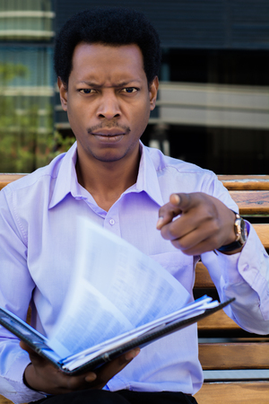 Professional young businessman angry shouting to someone outside office building.の写真素材