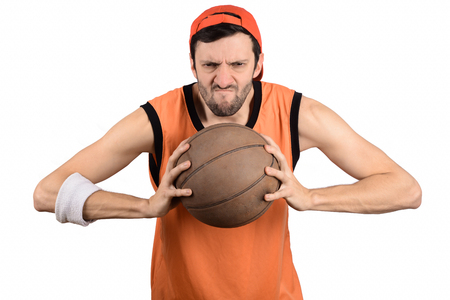 Portrait of young man with a funny expression and basketball ball. Sport concept.の写真素材