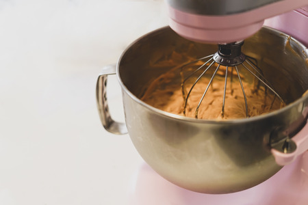 Close-up of a pink Stand Mixer, mixing something. Cooking concept.の写真素材
