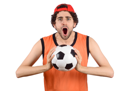 Portrait of young man with soccer ball and screaming. Sport concept.の写真素材