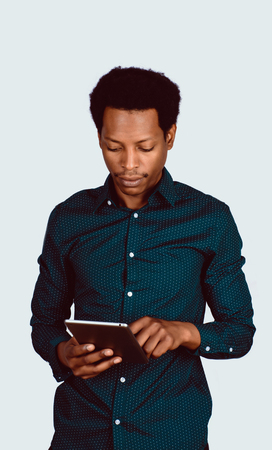 Portrait of Afro American man using digital tablet on studio.の写真素材