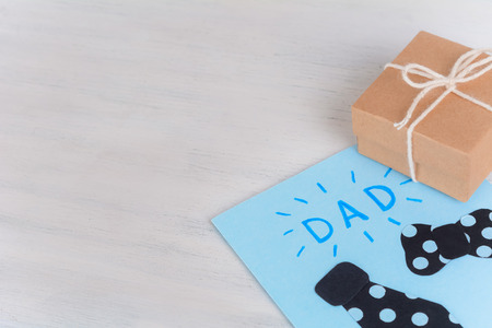 Fathers Day greeting card with gift box on wooden background. Fathers day conceptの写真素材