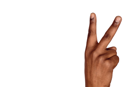 Man hand victory sign gesture. Hand with two fingers up. Isolated white backgroundの写真素材