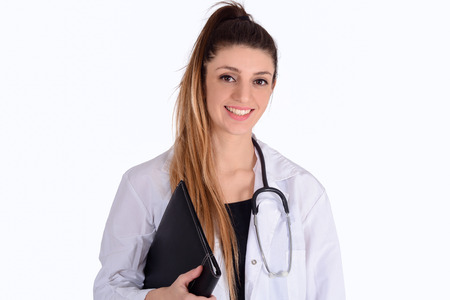 Portrait of young female doctor with stethoscope and holding folders on studio. Medical and healthcare concept.の写真素材