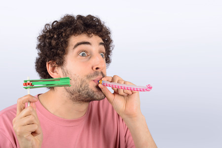 Portrait of young man with funny expression and a whistle.の写真素材