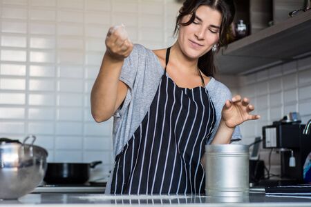 Young Woman Cooking in the kitchen at home. Healthy Food.