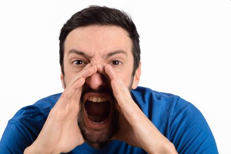 Portrait of young man shouting and screaming, studio shoot.