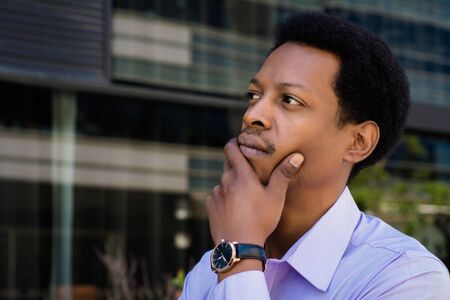 Focused Afro American businessman thinking in the city. Success in business