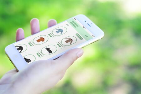 Close up view of woman shopping for clothes on smartphone. E-commerce concept. All screen graphics...