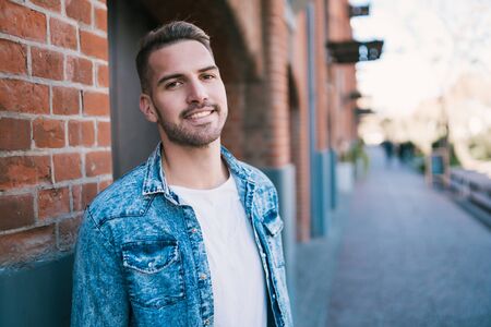 Portrait of young handsome man wearing casual clothes outdoors in the street. Urban concept.