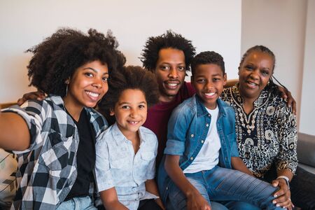 Portrait of african american multigenerational family taking a selfie together at home. Family and lifestyle concept.の写真素材