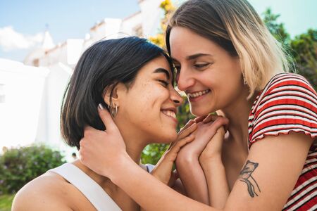 Portrait of loving lesbian couple spending time together and having a date outdoors. LGBT., love and relationship concept.の写真素材